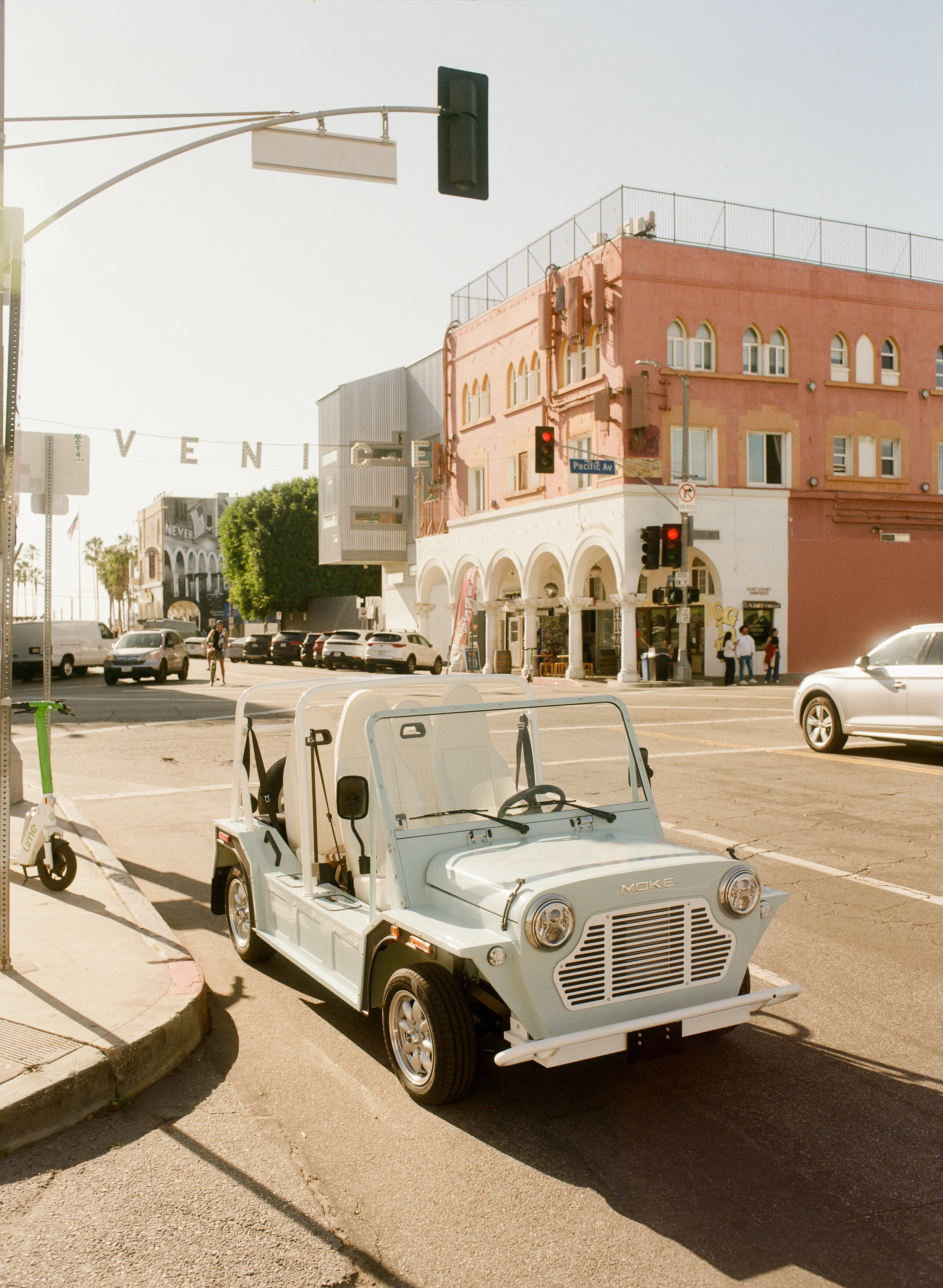 Open-air Moke on a palm-lined resort pathway