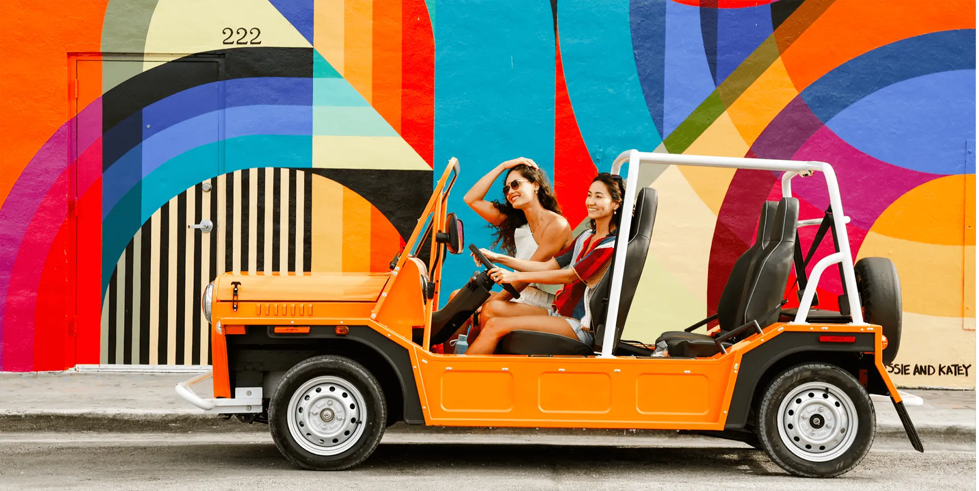 Moke EV driving along a cliffside coastal road in California with ocean views